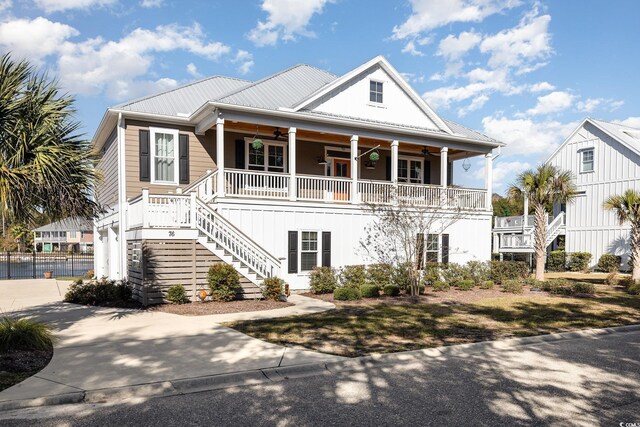 coastal inspired home featuring covered porch and ceiling fan