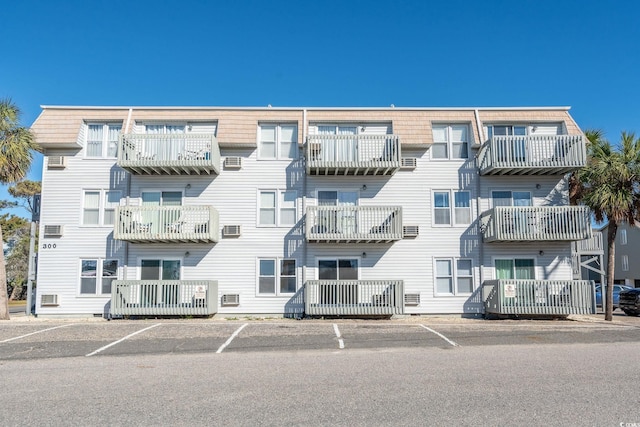 view of property with an AC wall unit