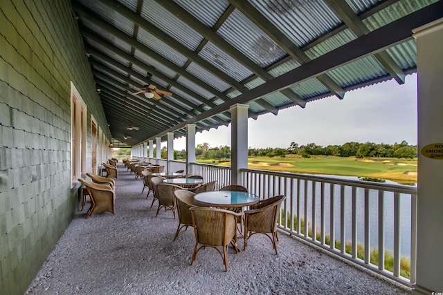 view of patio / terrace featuring ceiling fan and a water view