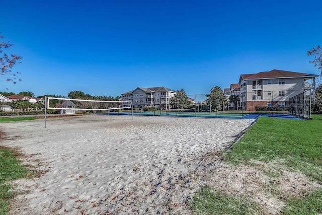 view of community with a lawn and volleyball court