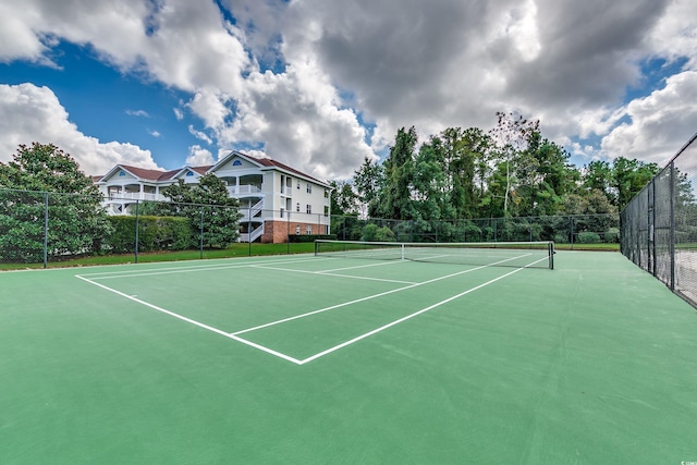 view of tennis court with basketball hoop