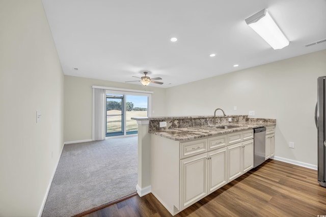 kitchen featuring appliances with stainless steel finishes, white cabinetry, sink, kitchen peninsula, and ceiling fan