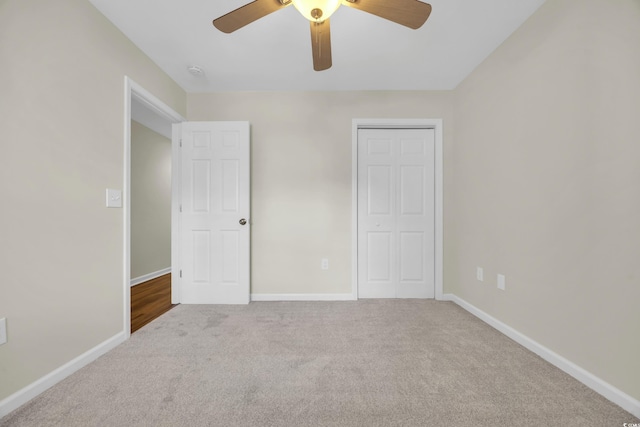 unfurnished bedroom featuring ceiling fan, a closet, and carpet floors