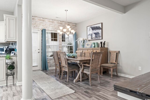 dining room with a chandelier and light wood-type flooring