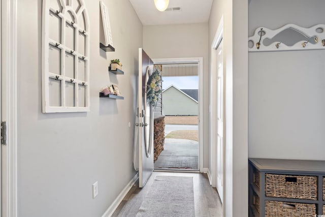 entryway with hardwood / wood-style floors