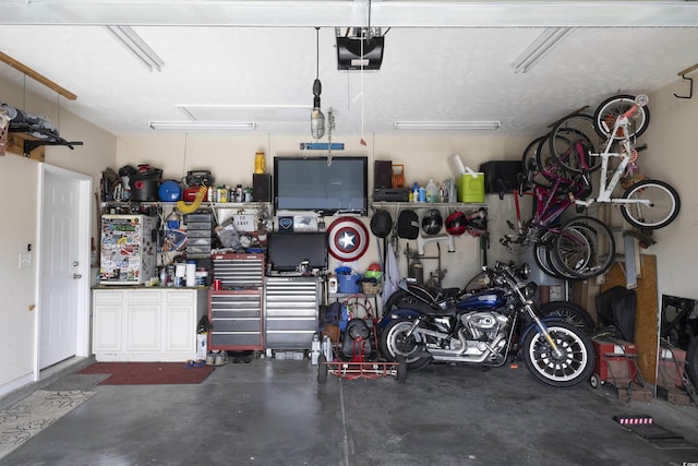 garage featuring a garage door opener and a workshop area