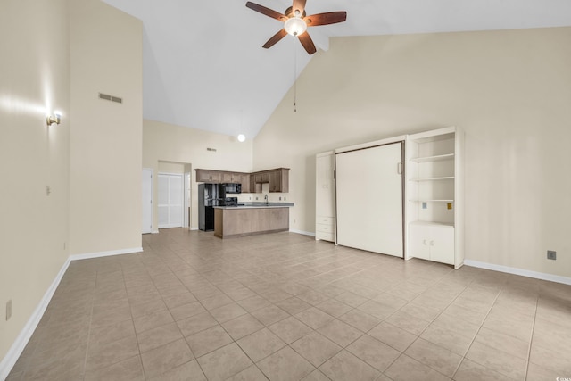 unfurnished living room featuring ceiling fan, high vaulted ceiling, and light tile patterned floors