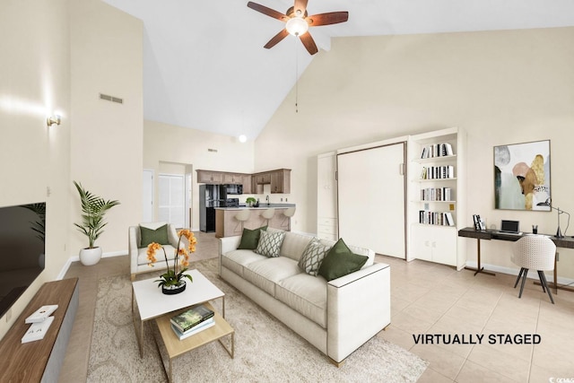 tiled living room with high vaulted ceiling and ceiling fan