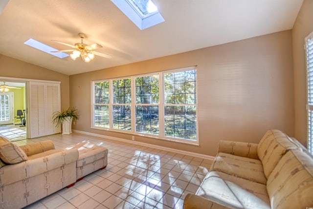 living room with ceiling fan, lofted ceiling, and light tile patterned flooring