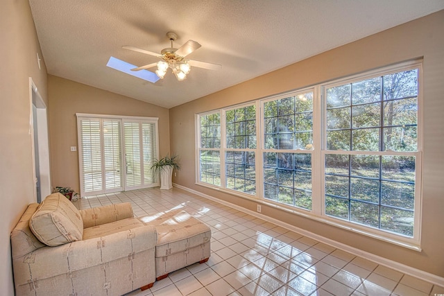 sunroom with vaulted ceiling with skylight and ceiling fan