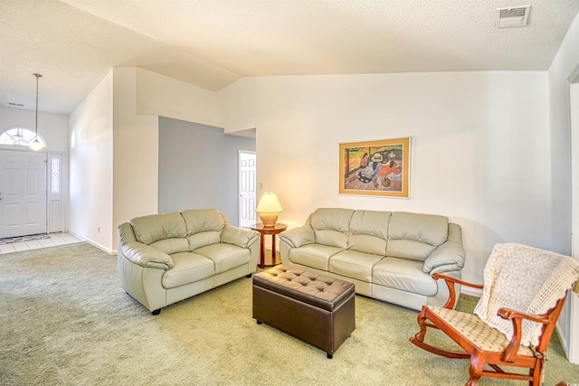 living room featuring carpet, a textured ceiling, and vaulted ceiling