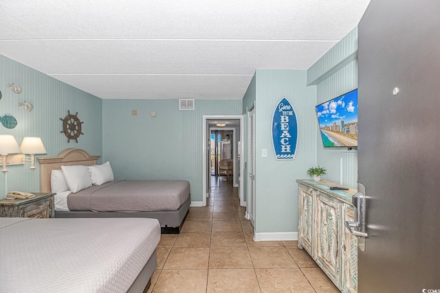 bedroom featuring visible vents, baseboards, and light tile patterned flooring