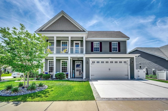 view of front of house with a front yard, a balcony, and a garage