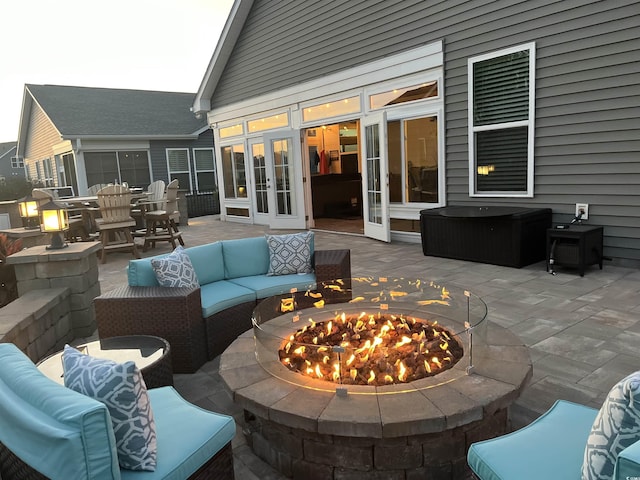 view of patio with french doors and an outdoor living space with a fire pit