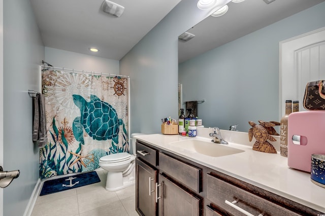 bathroom with tile patterned flooring, vanity, toilet, and walk in shower