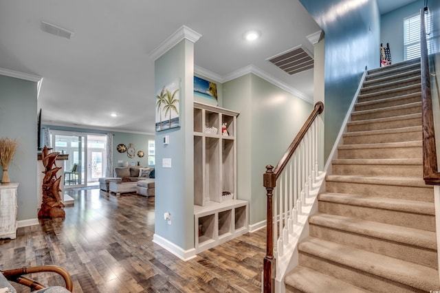 stairway with hardwood / wood-style floors and ornamental molding