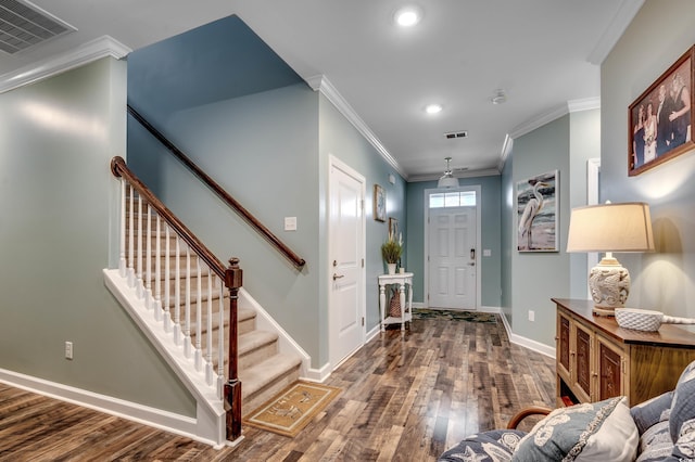 entryway with hardwood / wood-style flooring and ornamental molding