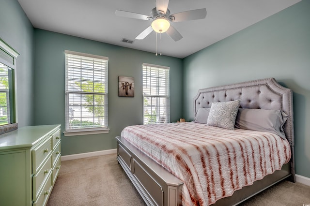 bedroom with light colored carpet and ceiling fan