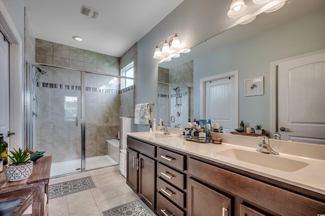 bathroom with tile patterned floors, vanity, and walk in shower