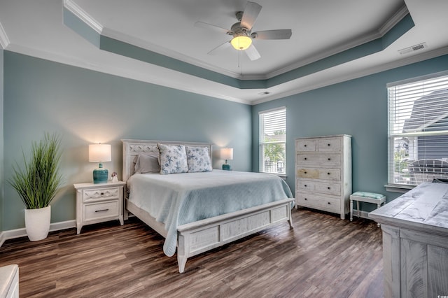 bedroom with dark hardwood / wood-style flooring, multiple windows, and crown molding