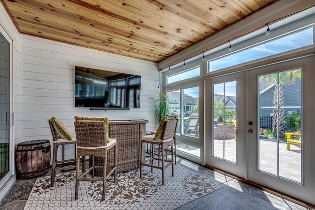 sunroom with wooden ceiling and french doors