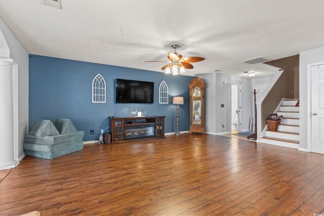 living room with wood-type flooring and ceiling fan