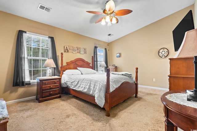 carpeted bedroom featuring ceiling fan and vaulted ceiling