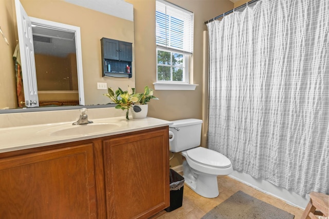 full bathroom with vanity, toilet, tile patterned flooring, and shower / bath combo with shower curtain