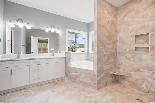 bathroom with vanity and a relaxing tiled tub