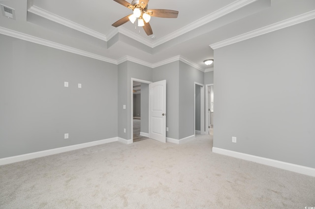 unfurnished bedroom featuring a tray ceiling, ceiling fan, and ornamental molding