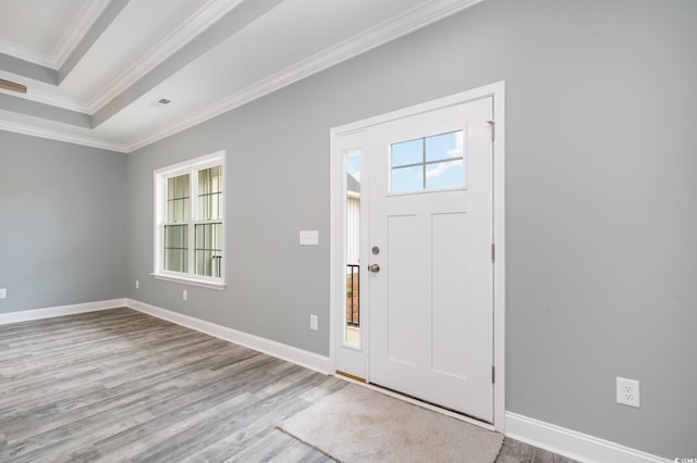 entryway with light wood-type flooring and ornamental molding