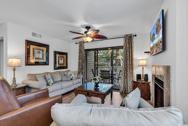 living room with light hardwood / wood-style floors and ceiling fan