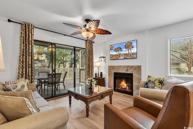 living room featuring ceiling fan and light wood-type flooring