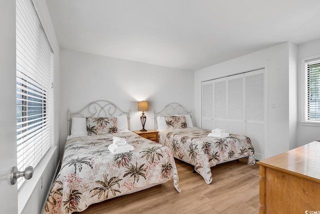 bedroom with a closet and light hardwood / wood-style floors