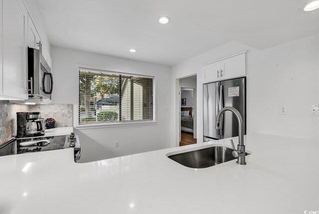 101 Westhill Cir Unit 5-C, Myrtle Beach, SC 29572 - kitchen with stainless steel appliances, light countertops, recessed lighting, white cabinetry, and decorative backsplash