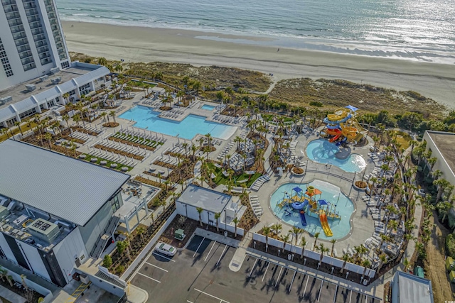 birds eye view of property featuring a water view and a beach view