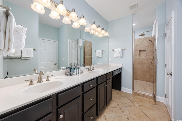 bathroom with walk in shower, vanity, and tile patterned flooring