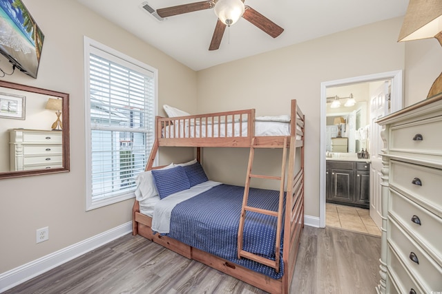 bedroom with ceiling fan, ensuite bathroom, and hardwood / wood-style floors