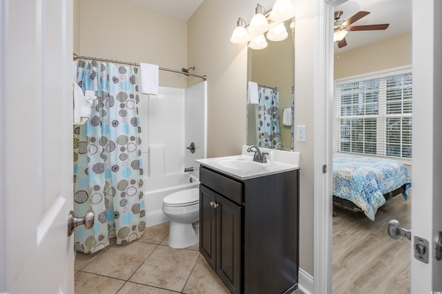 full bathroom with vanity, ceiling fan, toilet, tile patterned floors, and shower / bath combo with shower curtain