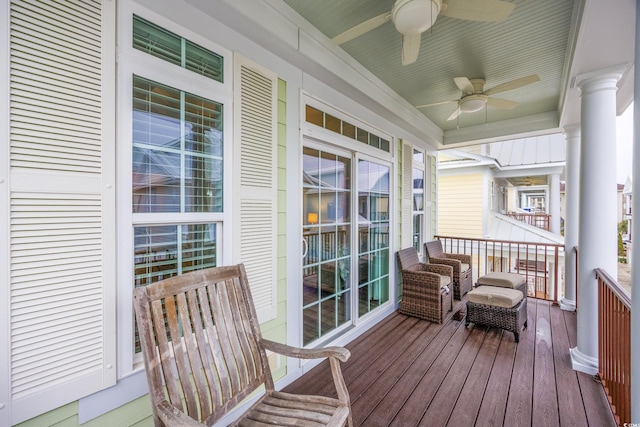 sunroom / solarium with ceiling fan and ornate columns