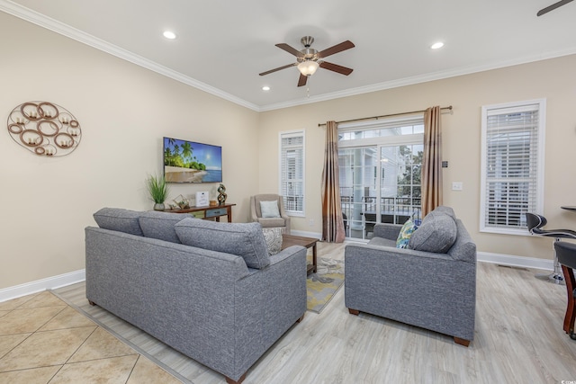 living room with ceiling fan, ornamental molding, and light wood-type flooring