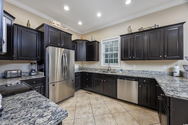 kitchen with sink, light stone counters, light tile patterned floors, ornamental molding, and appliances with stainless steel finishes