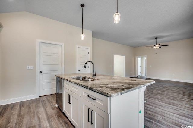 kitchen featuring pendant lighting, dishwasher, a kitchen island with sink, white cabinets, and sink