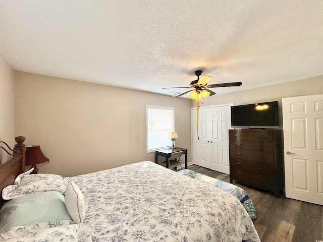 100 Dorman Cir, Myrtle Beach, SC 29577 - bedroom with dark wood-style flooring, a textured ceiling, a closet, and a ceiling fan