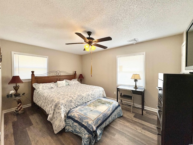 bedroom featuring multiple windows, ceiling fan, and dark hardwood / wood-style floors