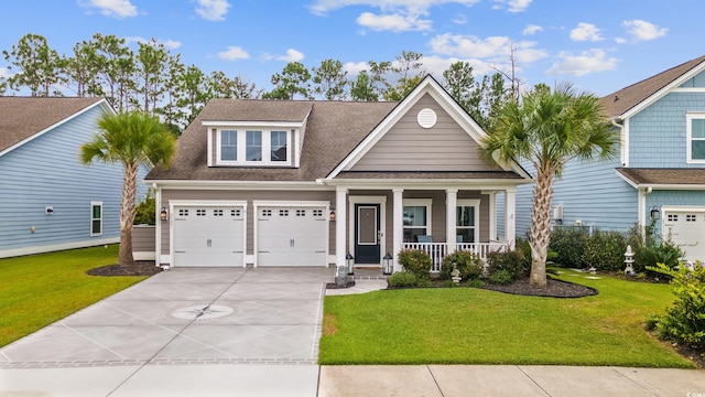 view of front of property featuring covered porch, a garage, and a front lawn