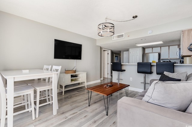 2701 S Ocean Blvd Unit 1808, North Myrtle Beach, SC 29582 - living area featuring a chandelier and light wood-style floors