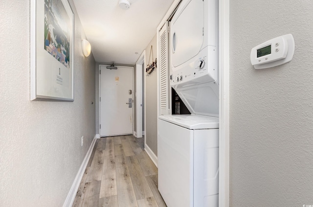 2701 S Ocean Blvd Unit 1808, North Myrtle Beach, SC 29582 - laundry room featuring stacked washer / drying machine, light wood-style flooring, and a textured wall