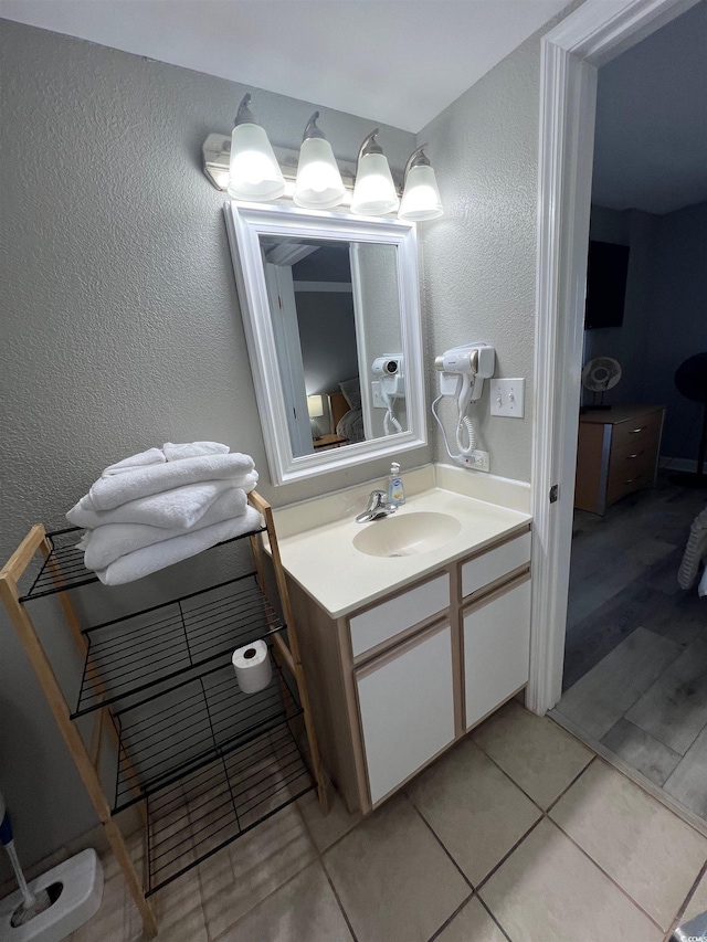 2701 S Ocean Blvd Unit 1808, North Myrtle Beach, SC 29582 - bathroom featuring vanity, a textured wall, and tile patterned floors
