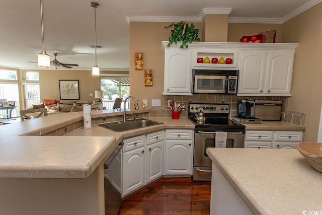 kitchen featuring ceiling fan, sink, pendant lighting, white cabinets, and appliances with stainless steel finishes